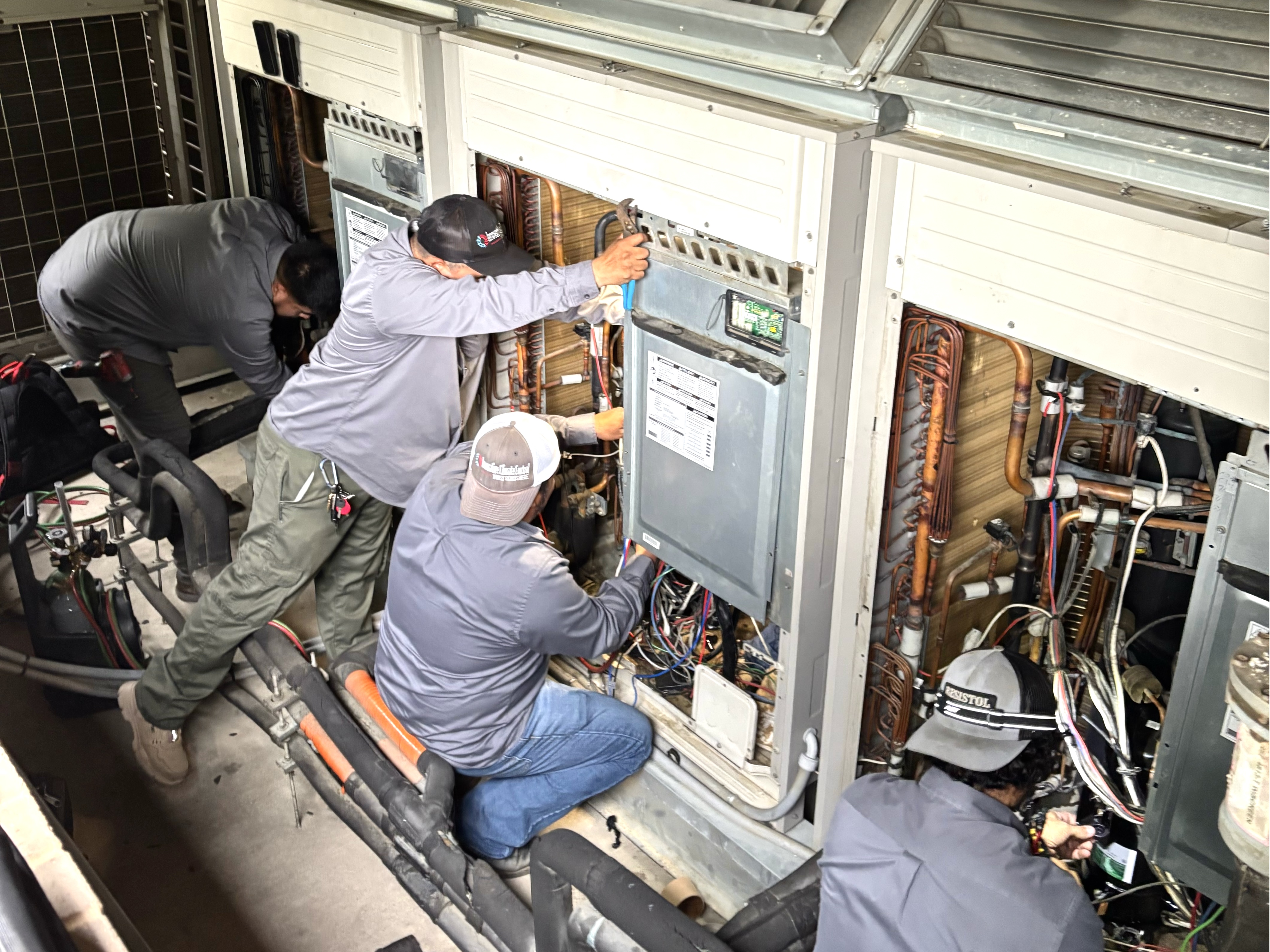 Crew working on rooftop commercial unit